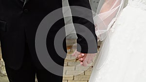 Closeup view of married couple holding hands