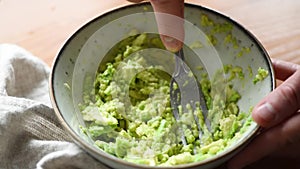 Closeup view of mashing avocado