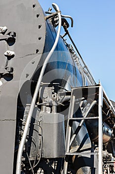 Closeup view of a mechanical equipment aroun a steam locomotive