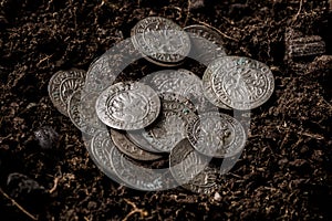 Closeup view of medieval European silver coins.Zygmunt III Waza.Ancient silver coins.Numismatics.silver coins covered in dirt.