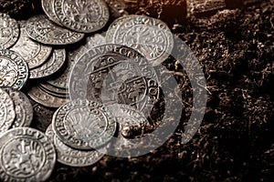 Closeup view of medieval European silver coins.Zygmunt III Waza.Ancient silver coins.Numismatics.silver coins covered in dirt.