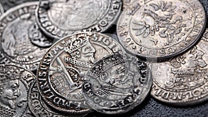 Closeup view of medieval European silver coins.Zygmunt III Waza.Ancient silver coins.Numismatics.silver coins covered in dirt.