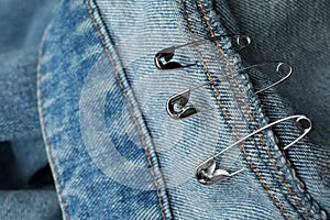 Closeup view of metal safety pins on clothing