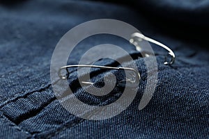 Closeup view of metal safety pins on clothing