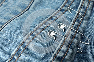 Closeup view of metal safety pins on clothing