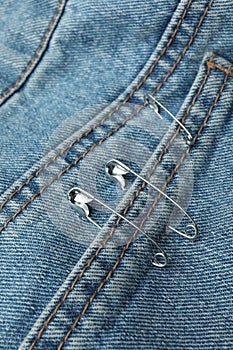 Closeup view of metal safety pins on clothing