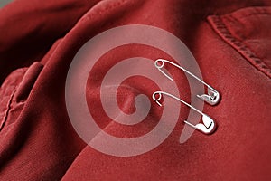 Closeup view of metal safety pins on clothing