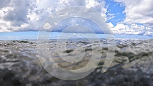 A closeup view of ocean waves lapping on the beach along the shoreline in the Cayman Islands