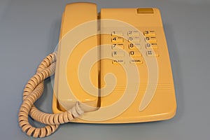 Closeup view of old style wired desktop telephone - studio shot