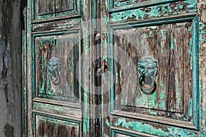 Old wooden door with two doorknobs in Murano, Italy photo