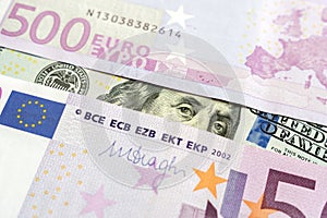 Closeup view of one hundred dollars banknote with euro money banknotes around as financial background. Cash money. Money