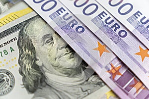 Closeup view of one hundred dollars banknote with euro money banknotes around as financial background. Cash money. Money