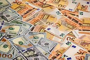 Closeup view of one hundred dollars banknote with euro money banknotes around as financial background.1