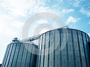 Closeup view of paddy rice storage steel silo in a milling plant. Agriculture produces storage technologies.