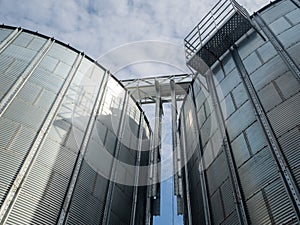 Closeup view of paddy rice storage steel silo in a milling plant. Paddy, grain, and corn storage vertical warehouse.