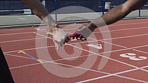 Closeup view of participant handing off baton to next runner, world championship