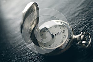 Closeup view of a pocketwatch on a slate - soft focus technique,