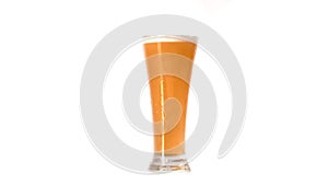 Closeup view of pouring lager beer in high glass in white background, slow motion, alcoholic drink