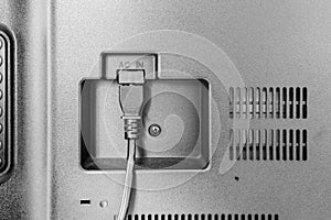 Closeup view of power cable plug into the television input