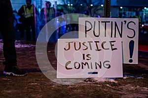 Closeup view of protester banners against Putin with riot police on the background photo