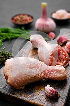 Closeup view of raw chicken legs on cutting board ready for cooking