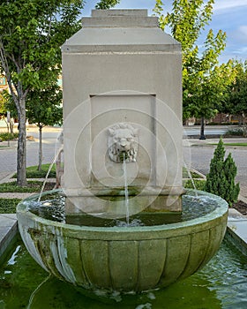 Closeup view of a replica fountain in front of the historic Vandergriff Office Building in Arlington, Texas.