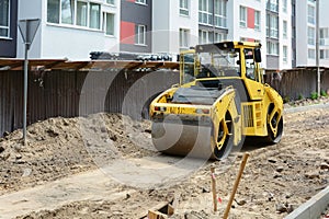 Closeup View on the road roller working on the new road construction site