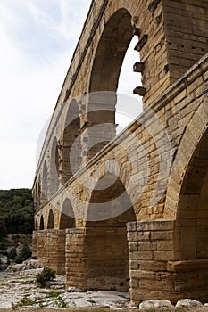 Closeup view of Roman built Pont du Gard aqueduct, Vers-Pont-du-Gard in South of France.