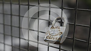 Closeup view of small locks of love near the bridge