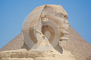 Closeup view of the Sphinx head with pyramid in Giza near Cairo, Egypt