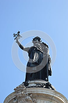 Closeup view of statue of Liberty in Place de la Republique in Paris with blue sky in bacground