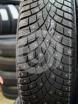 Closeup view of a studded winter tire tread
