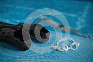 Closeup view on swimming accessories at poolside, selective focus