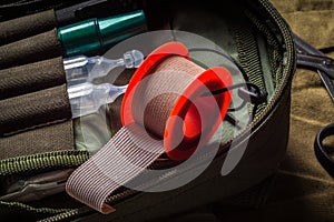 Closeup view of textile medical tape roll in pocket military first aid kit. First aid in an emergency