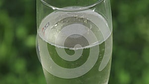 Closeup view to bubbles in a glass of sparkling wine champagne