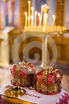 Closeup view to wedding crowns on embroidered towel during a wedding ceremony in Orthodox Ukrainian church