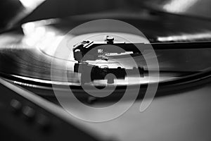 Closeup view of a tonearm and turntable playing vinyl record