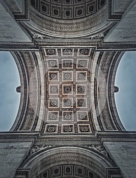 Closeup view underneath triumphal Arch, in Paris, France. Architectural details and ceiling ornate pattern of the famous Arc de