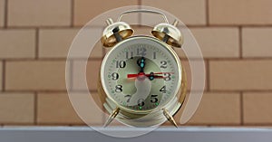 Closeup View Of Vintage Alarm Clock Over Brick Wall Background