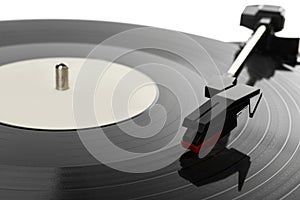 Closeup view of vinyl record on turntable against white background