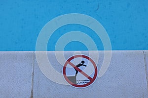 Closeup view of warning sign on outdoor swimming pool.