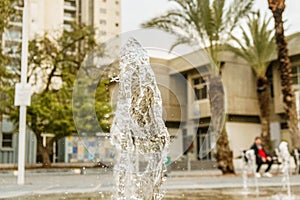 Closeup view on water splash fountain. Liquid motion spray.