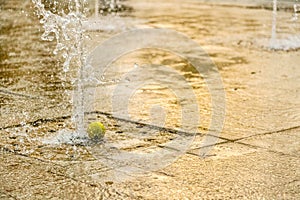 Closeup view on water splash fountain. Liquid motion spray.