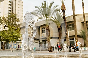 Closeup view on water splash fountain. Liquid motion spray.