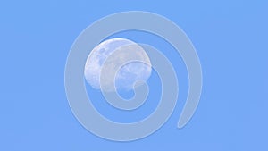 Closeup view of a waxing crescent moon in the blue sky