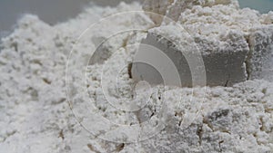 Closeup view of wheat flour heap placed in market for sale