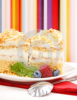 Closeup view of whipped cream cake garnished with berries