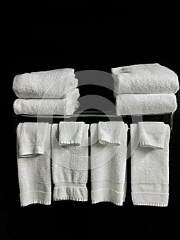 closeup view of a white fresh clean towels on dark wall background