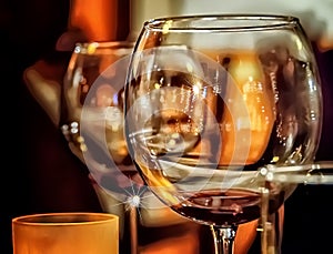 Closeup view of wine goblet with bar, restaurant background. photo