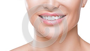 Closeup view of a woman`s smile with white healthy teeth, isolated on white